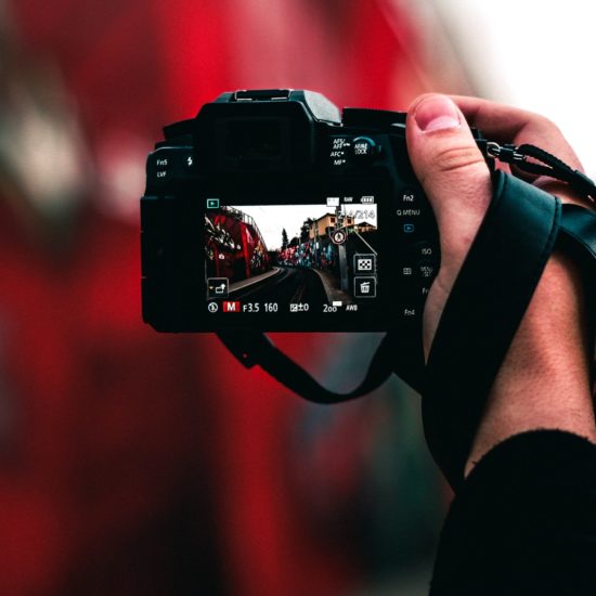 black DSLR camera capturing road